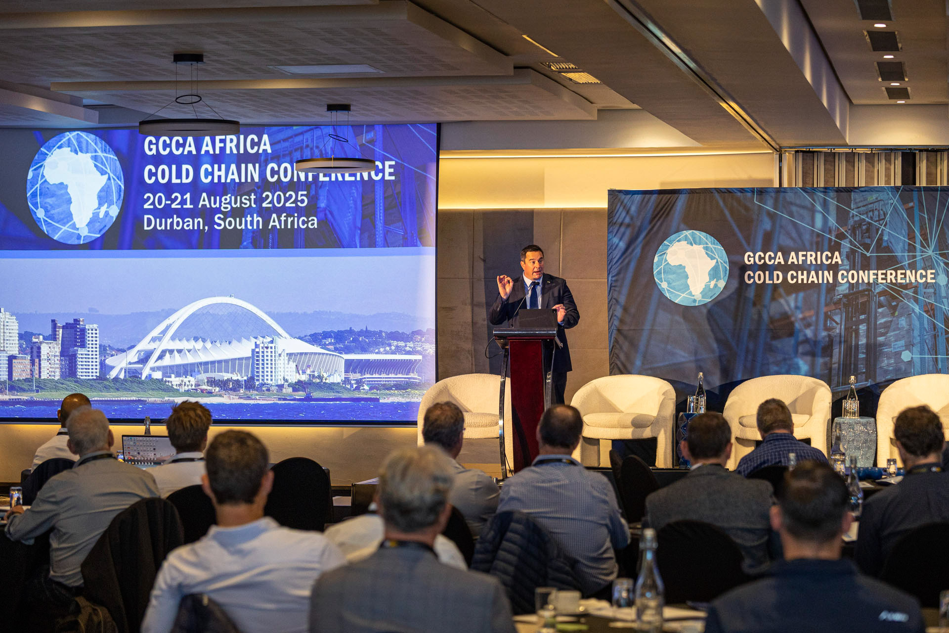 Keynote speaker John Steenhuisen on stage with professional AV staging at the GCCA Africa Hybrid Conference, Durban.